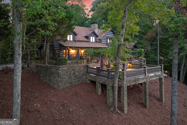 view of back house at dusk