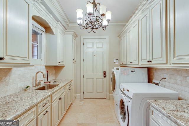 laundry area with a chandelier, cabinets, crown molding, washer and dryer, and sink