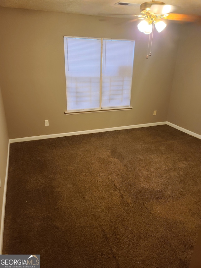 carpeted empty room featuring ceiling fan