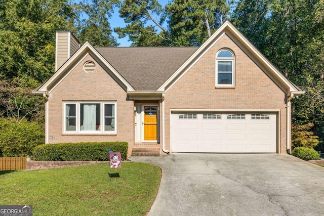 view of front of house with a front yard and a garage