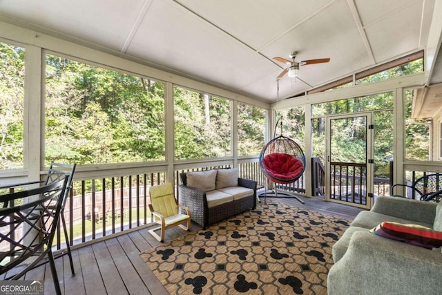 sunroom / solarium with ceiling fan, lofted ceiling, and a wealth of natural light