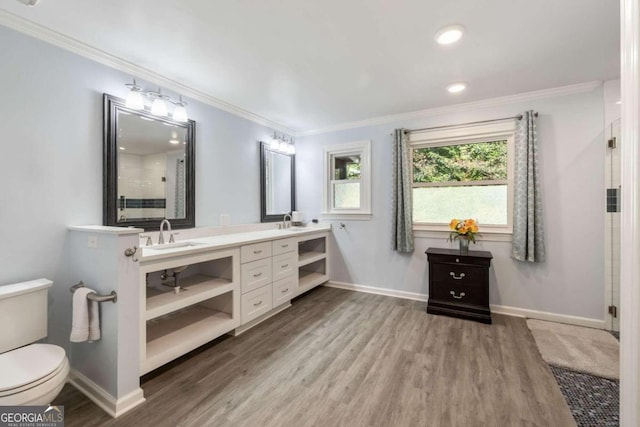 bathroom featuring ornamental molding, hardwood / wood-style flooring, vanity, and toilet