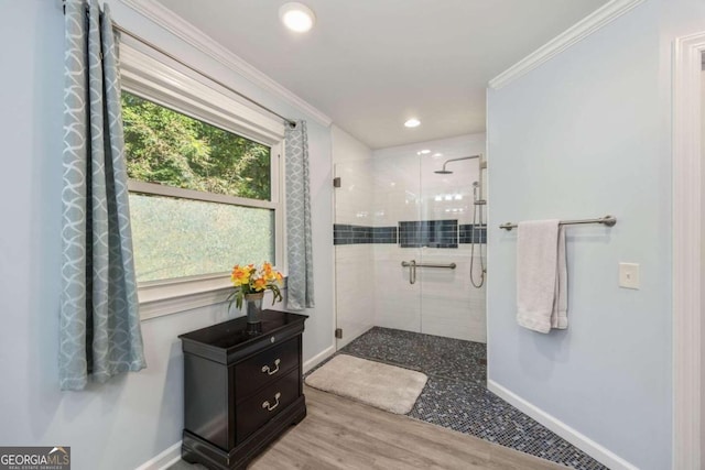 bathroom featuring an enclosed shower, ornamental molding, and hardwood / wood-style flooring