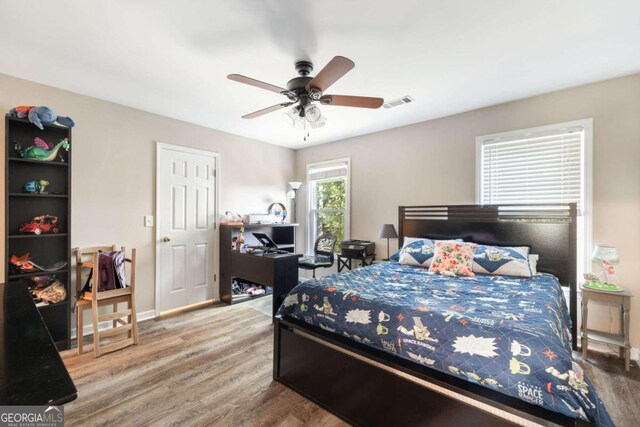 bedroom with hardwood / wood-style floors and ceiling fan