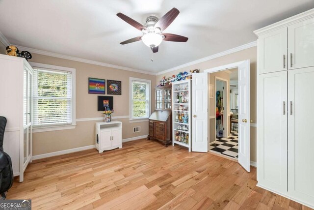 office with ceiling fan, light hardwood / wood-style flooring, and ornamental molding