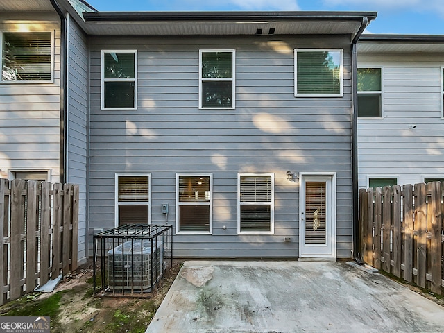 rear view of house with cooling unit and a patio