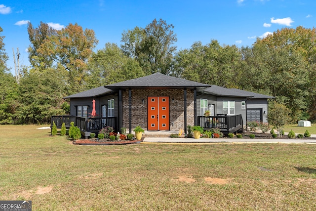 view of front of property with a wooden deck and a front lawn