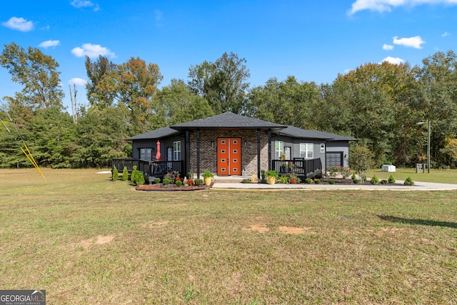 view of front of property featuring a front lawn and a wooden deck