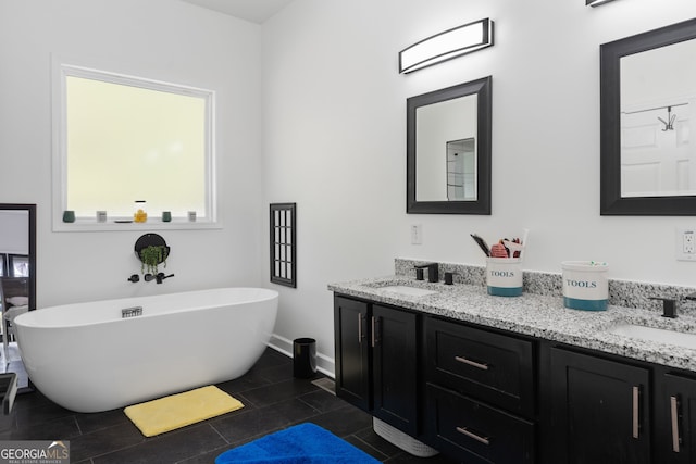 bathroom with vanity, tile patterned flooring, and a washtub