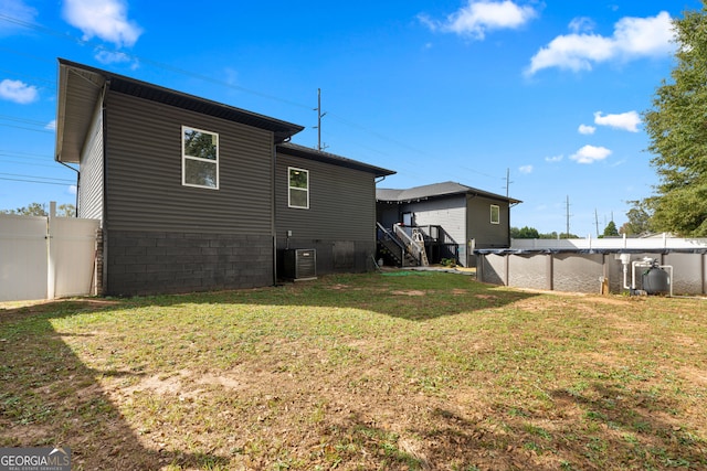 rear view of property featuring a lawn