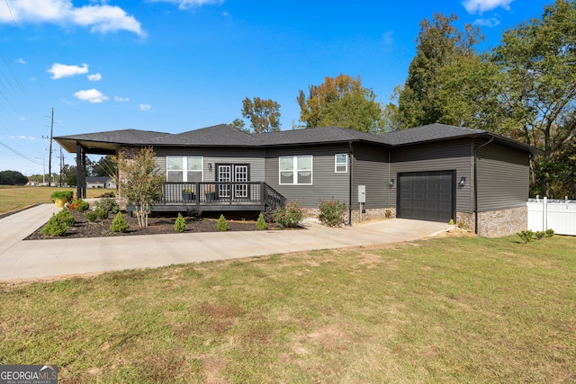 ranch-style home with a front yard, a deck, and a garage