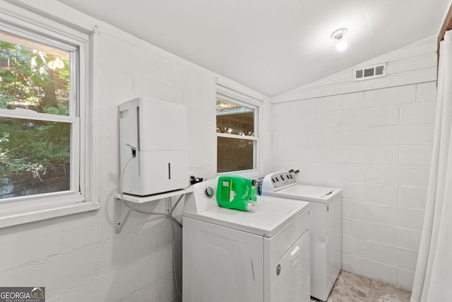 clothes washing area with separate washer and dryer