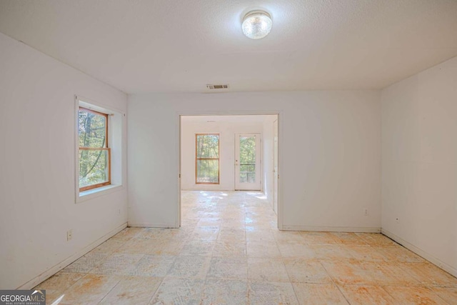 unfurnished room featuring a skylight and a wealth of natural light