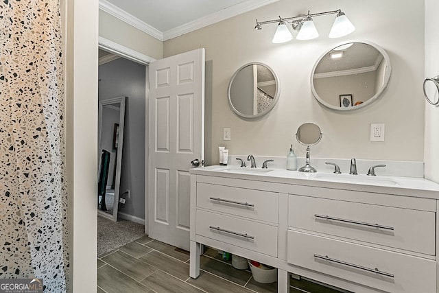 bathroom with ornamental molding, hardwood / wood-style floors, and vanity