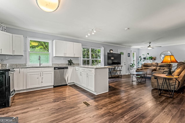 kitchen with stainless steel appliances, white cabinets, light stone counters, and dark wood-type flooring