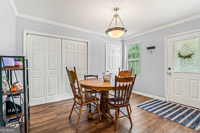 dining area featuring ornamental molding and dark wood-type flooring