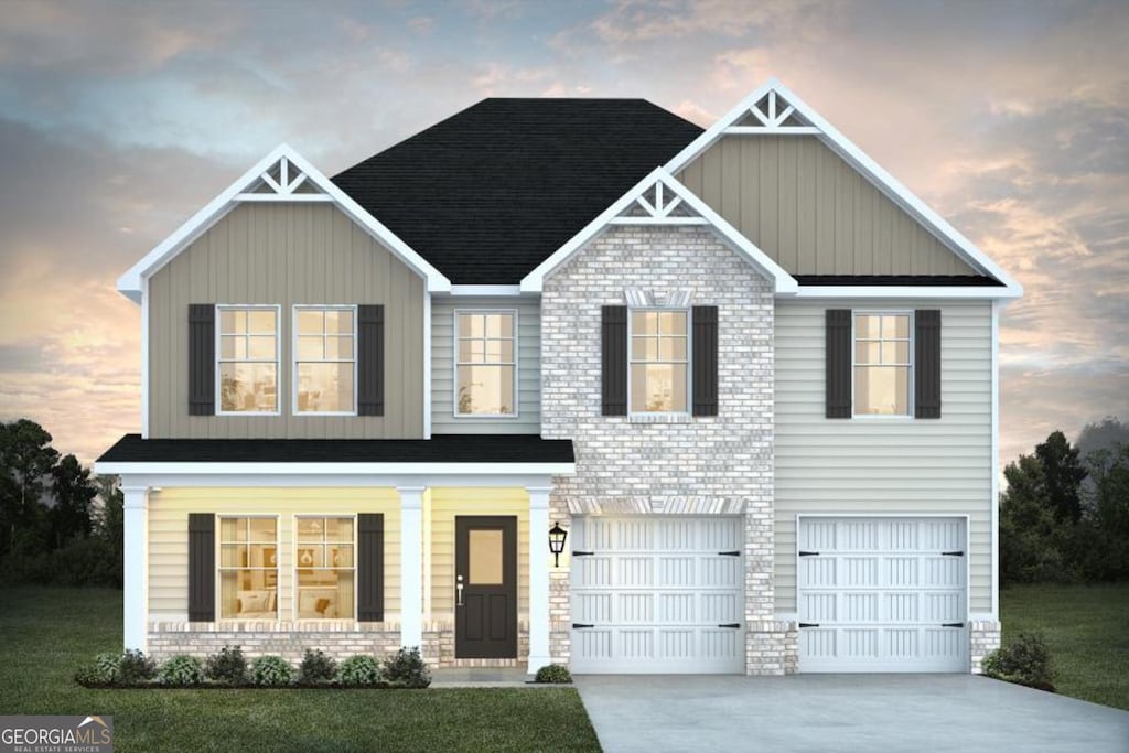 craftsman-style house featuring a lawn and a garage