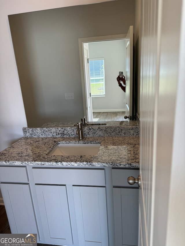 bathroom with vanity and hardwood / wood-style floors