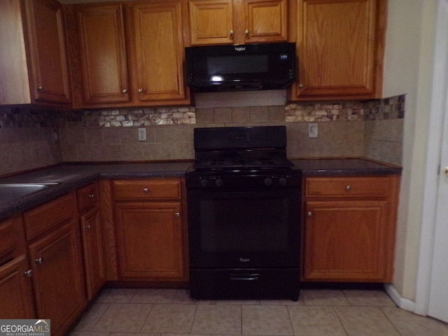 kitchen featuring black appliances, light tile patterned floors, and decorative backsplash