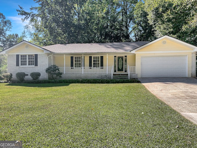 ranch-style home with a garage, a front lawn, and covered porch