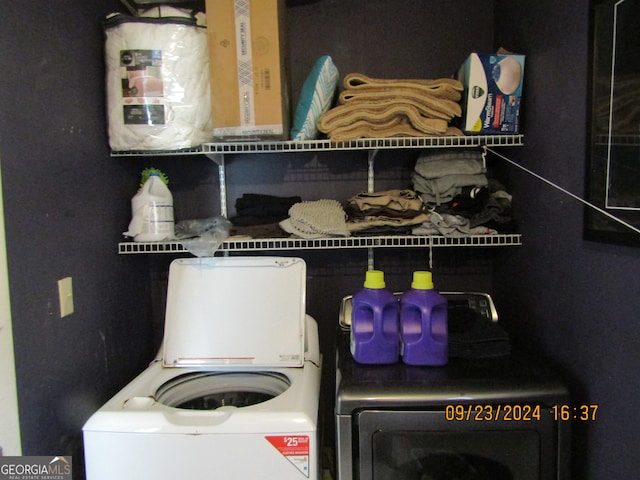 laundry area with washing machine and clothes dryer