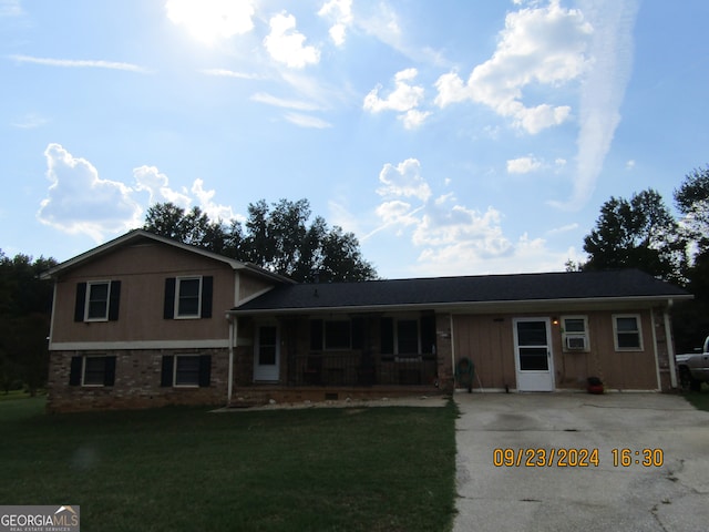 split level home featuring a front lawn and covered porch