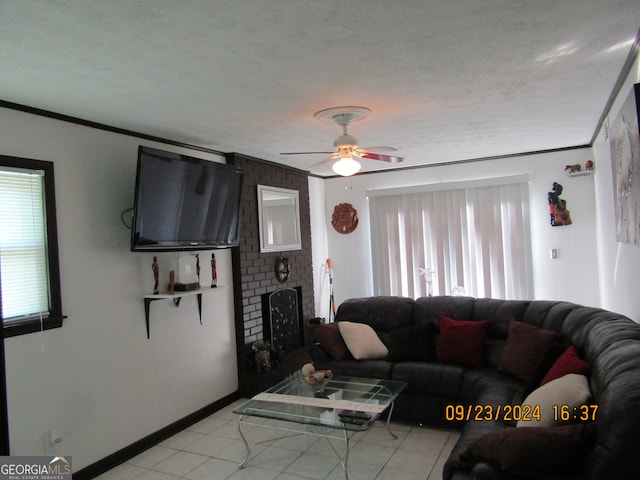 living room featuring plenty of natural light, a textured ceiling, and ceiling fan