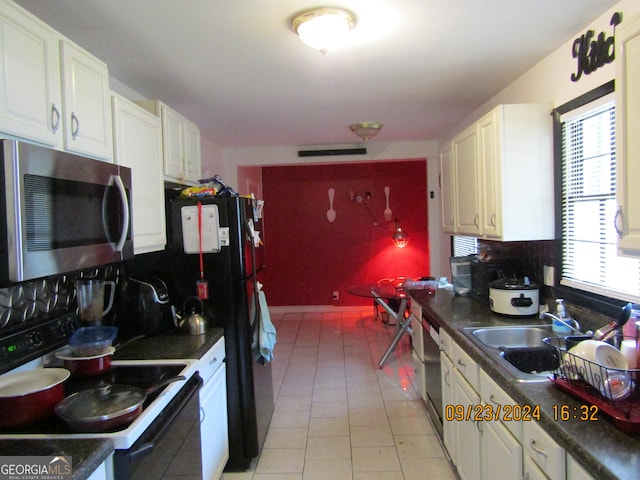 kitchen featuring white cabinets, stainless steel appliances, and plenty of natural light