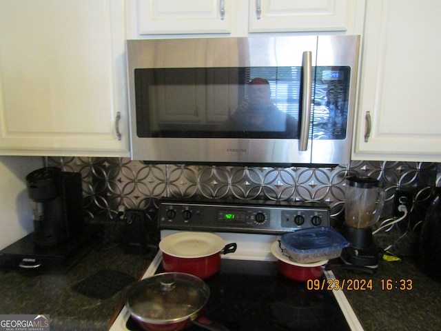 details featuring white cabinets and decorative backsplash