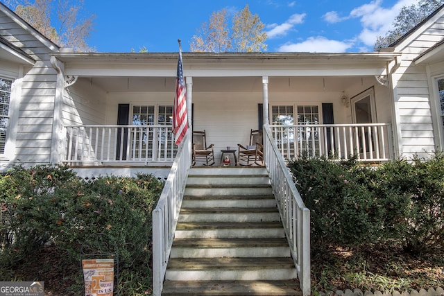 view of exterior entry with covered porch