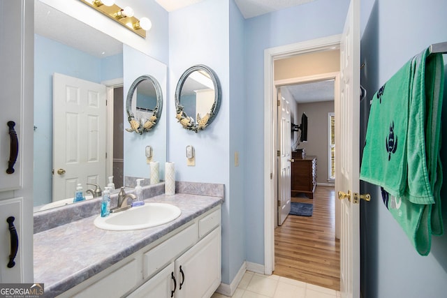 bathroom featuring wood-type flooring, a textured ceiling, and vanity