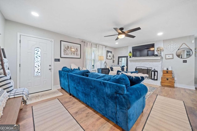 living room with ceiling fan and light hardwood / wood-style floors