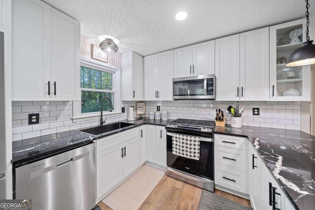 kitchen featuring white cabinets, appliances with stainless steel finishes, and sink