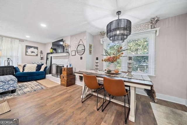 dining area with hardwood / wood-style flooring and a chandelier