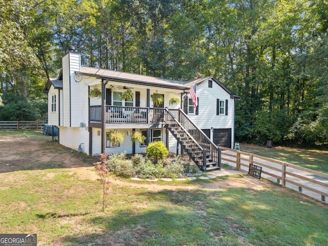 view of front of house featuring a front lawn, a porch, and a garage