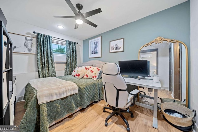 bedroom with ceiling fan and wood-type flooring