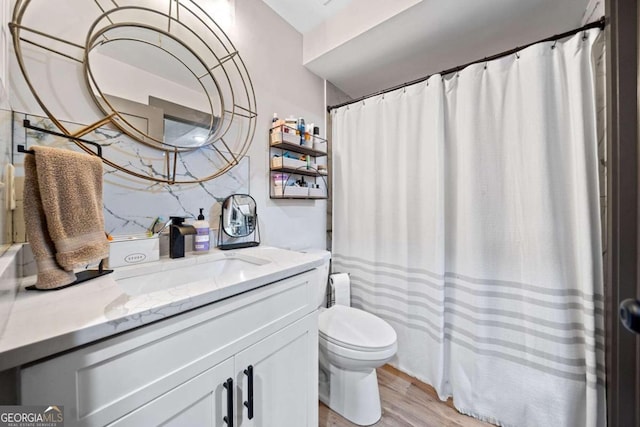 bathroom featuring a shower with curtain, hardwood / wood-style floors, vanity, and toilet