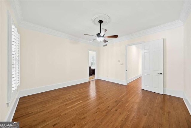 interior space featuring wood-type flooring, ornamental molding, and ceiling fan