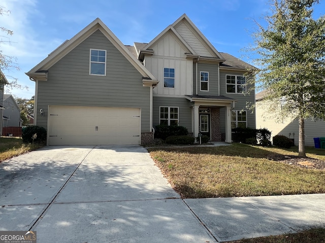 view of front of house featuring a front lawn and a garage