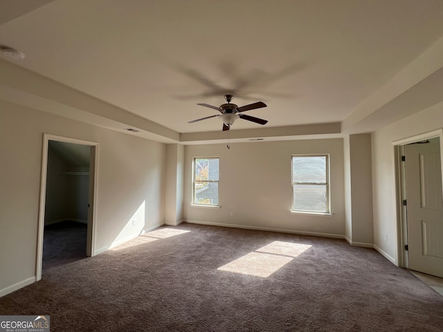 carpeted empty room featuring ceiling fan