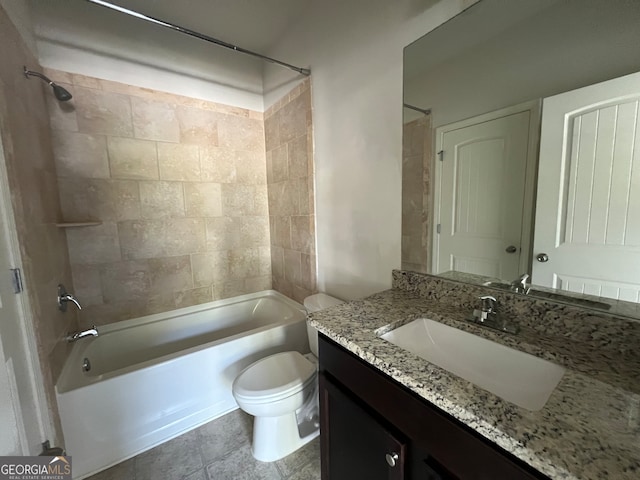 full bathroom featuring toilet, tiled shower / bath combo, vanity, and tile patterned floors