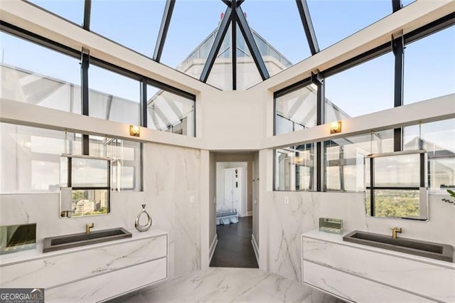 bathroom with tile walls and a high ceiling