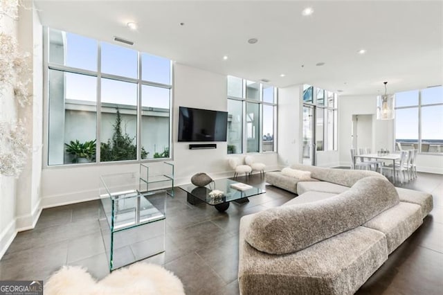 living room featuring a wall of windows and a chandelier