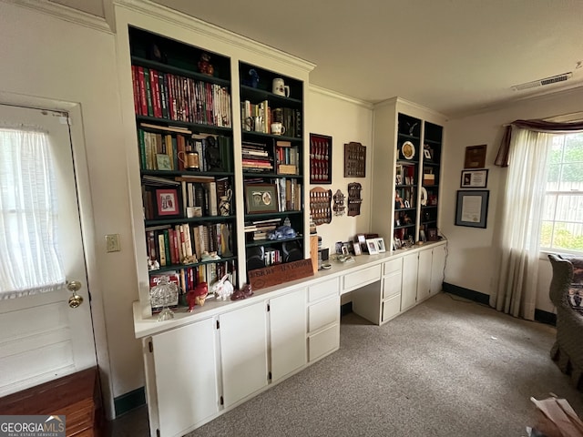 carpeted office space with built in desk