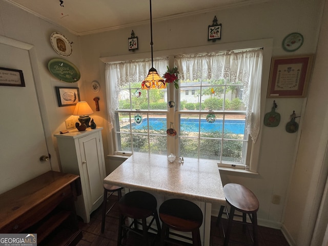 dining area with crown molding and plenty of natural light