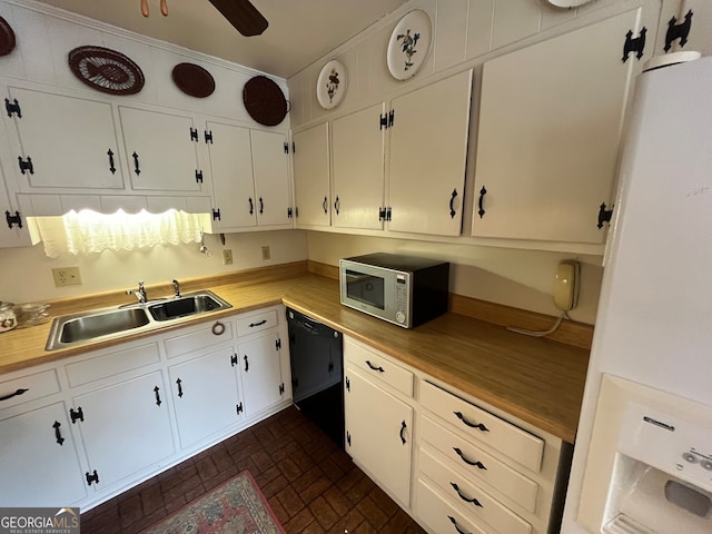 kitchen with wooden counters, sink, dishwasher, white fridge, and white cabinetry