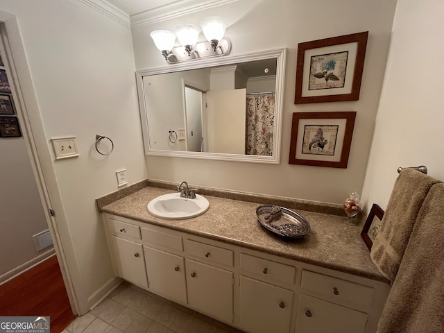 bathroom featuring ornamental molding, tile patterned flooring, and vanity