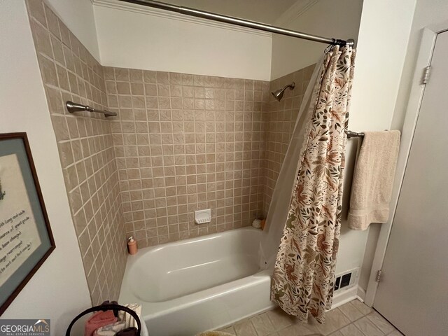 bathroom with tile patterned flooring and shower / bath combo with shower curtain