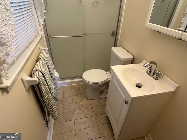 bathroom with an enclosed shower, tile patterned floors, vanity, and toilet