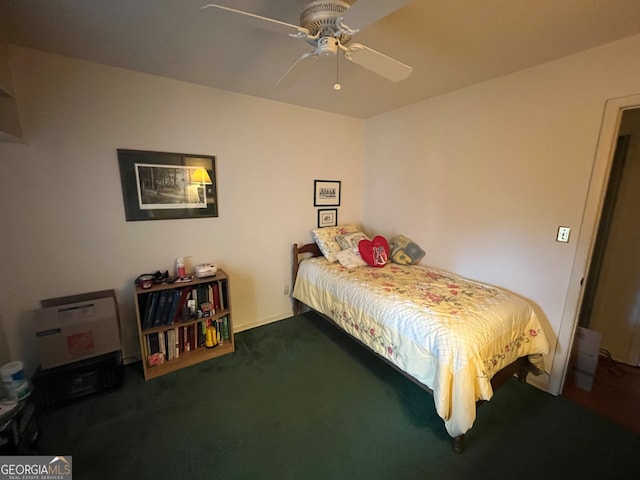 bedroom with ceiling fan and dark carpet